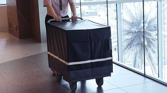 Staff wearing dedicated uniforms collect and deliver cargo in the facility via the optimal routes